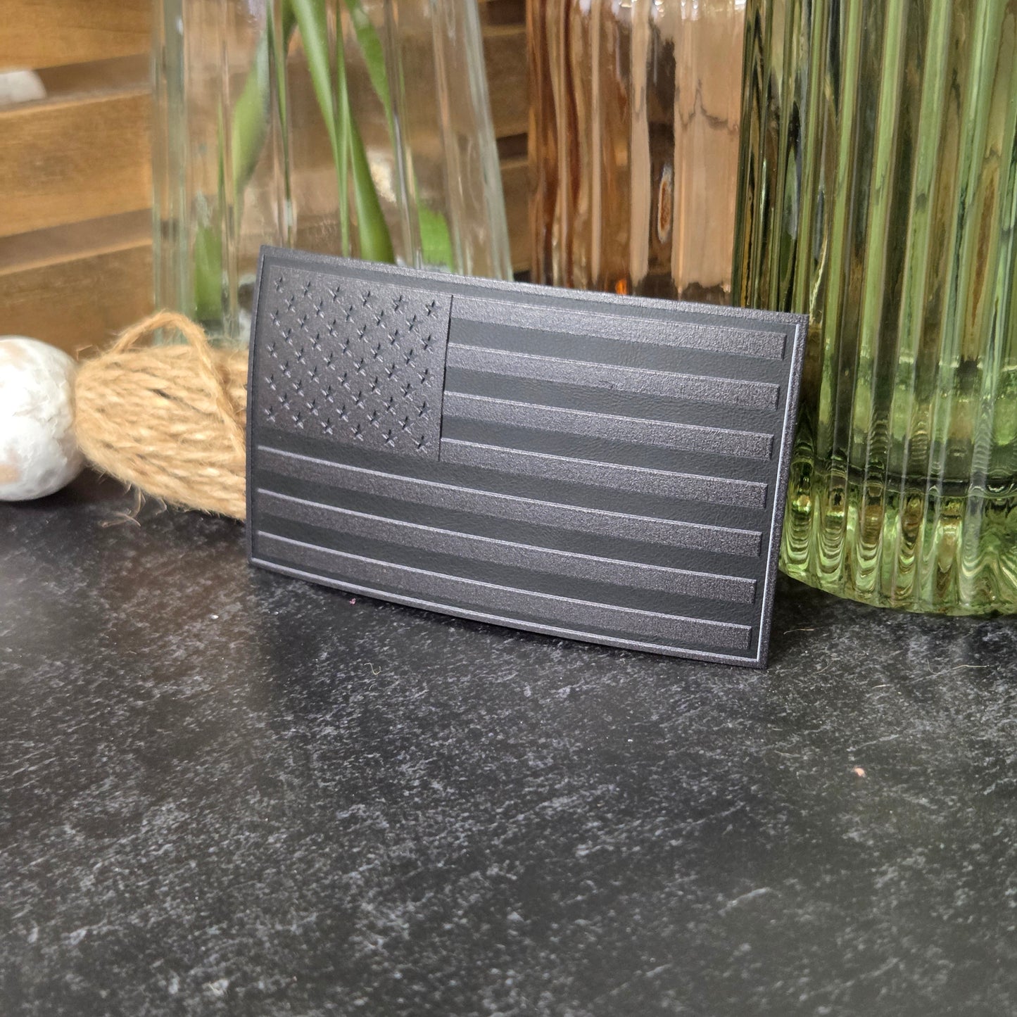 Blackout American Flag with textured surface on a dark surface