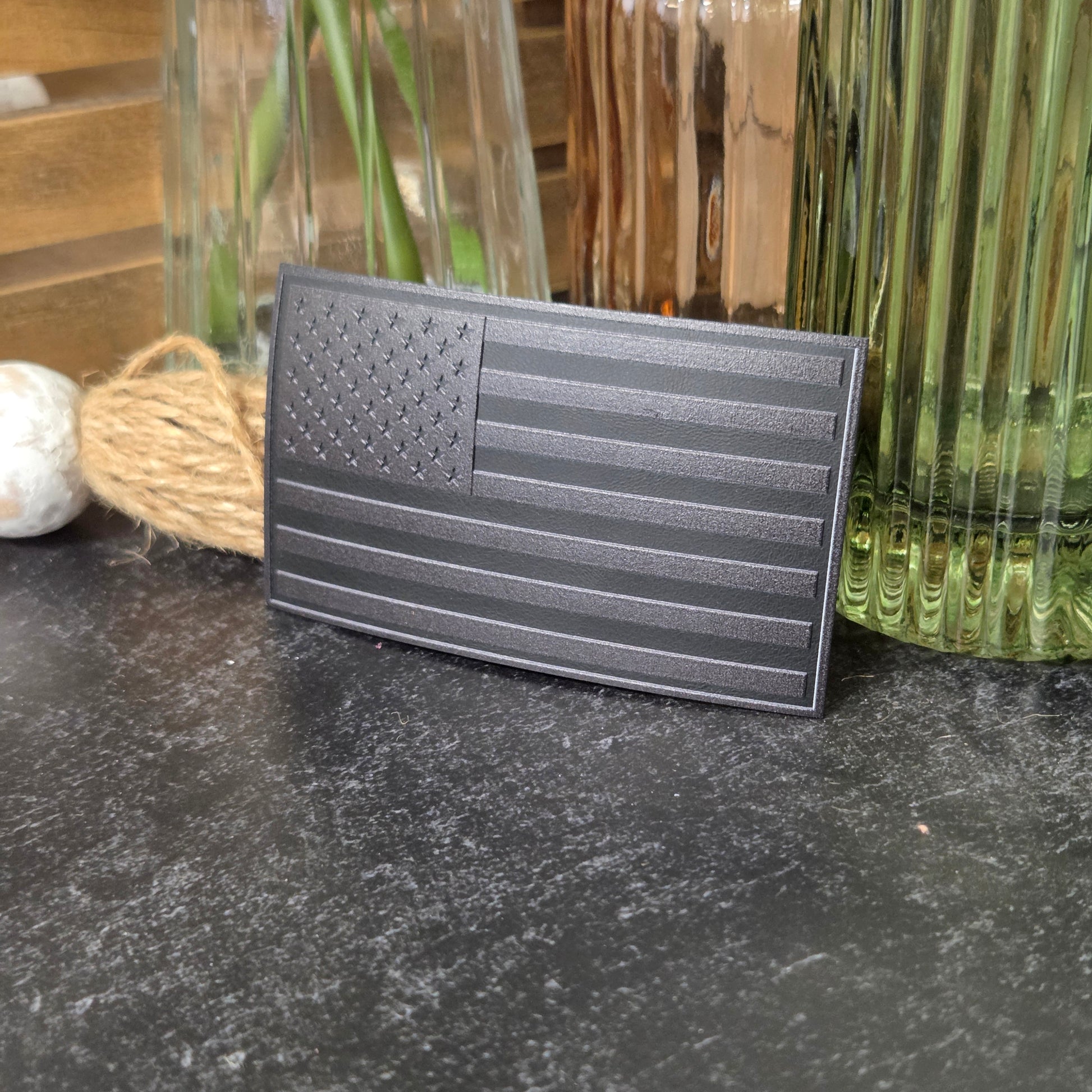 Blackout American Flag with textured surface on a dark surface