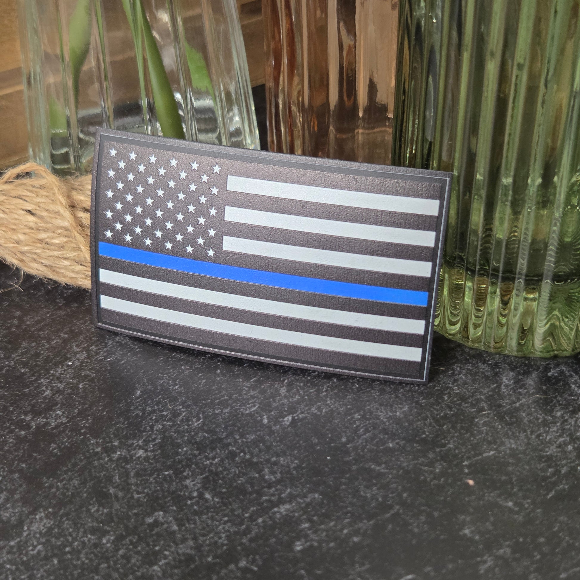 American flag patch with thin blue line on a textured surface