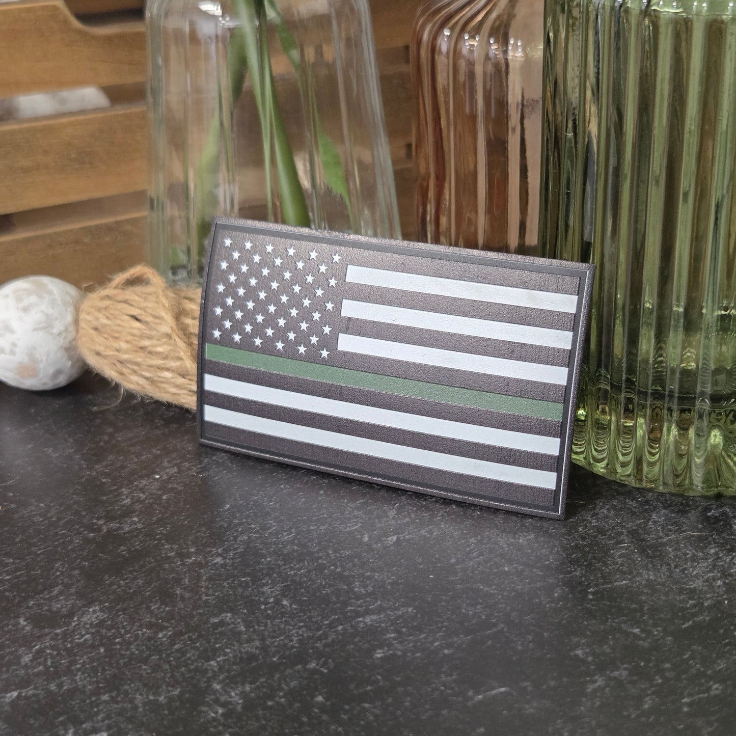 American flag patch with green line on a textured surface